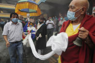 Friends and family members accompany a chariot carrying the body of veteran Nepalese Sherpa guide Ang Rita, during his funeral in Kathmandu, Nepal, Wednesday, Sept. 23, 2020. Ang Rita, who was the first person to climb Mount Everest 10 times has died Monday at age 72 after a long illness. (AP Photo/Niranjan Shrestha)