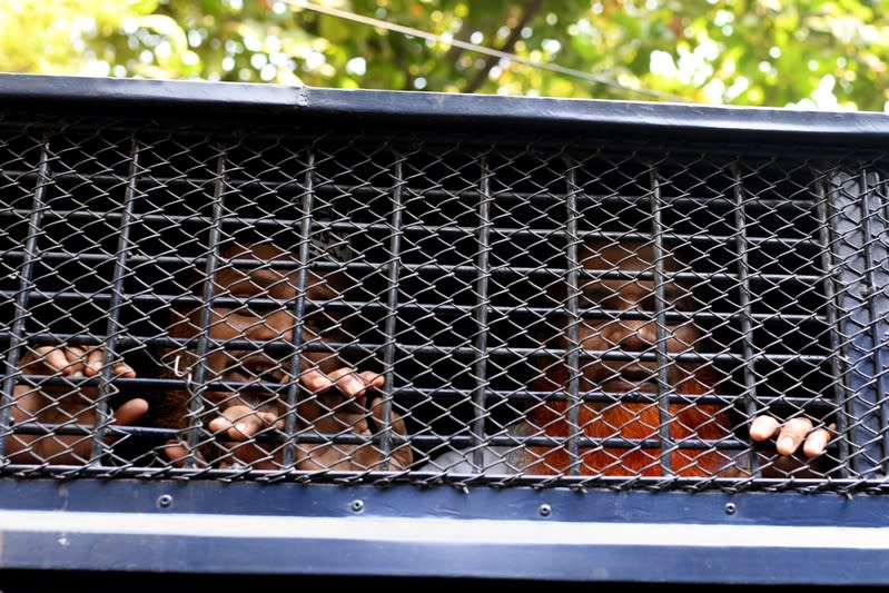 Accused of Holey Artisan Bakery attack are seen inside prison van as they are taken out of the court after hearing a verdict in Dhaka