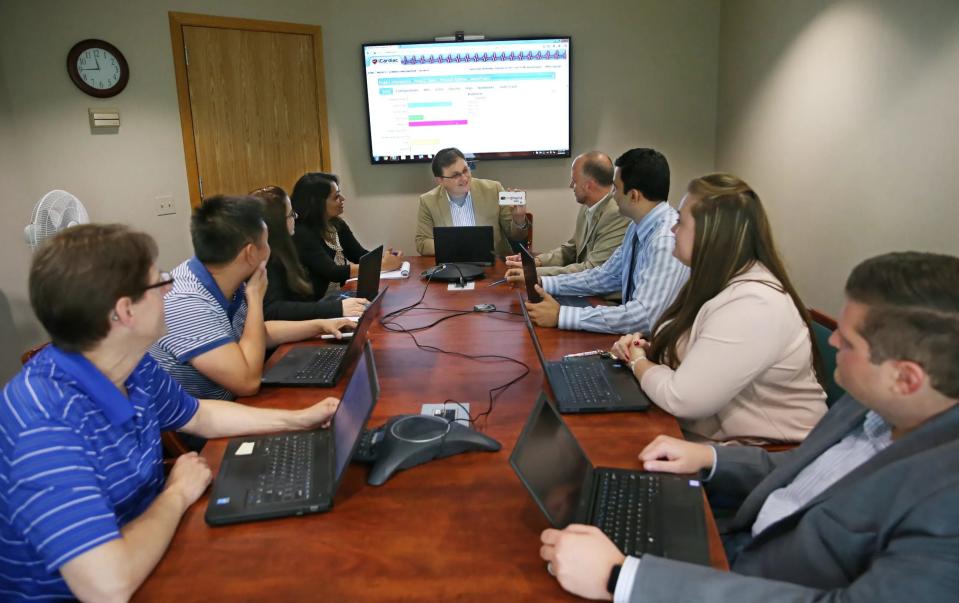 President and CEO Alex Zapesochny, top center, meets with his team at iCardiac Technologies. From left are, Jay Baker, chief financial officer; Thuan Pham, director of software development; Charcy Schultz, director of quality and regulatory compliance; Smriti Jacob, senior manager, marketing and communications; Zapesochny; Brian Smith, vice president of project operations; Kamlesh Naidu, director of data management; Kristy Ioele, human resources manager; and Dave Mullaney, director of information technology.