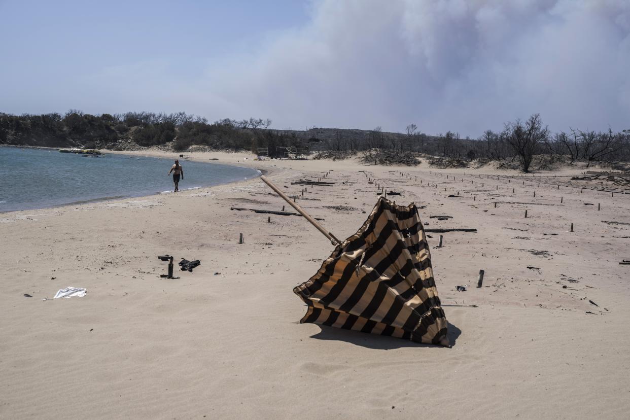 Burned sunbeds and umbrellas at a beach on the island of Rhodes.