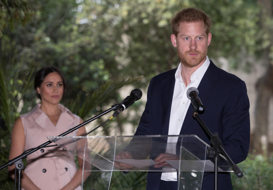 Prince Harry addesses the press in Johannesburg South Africa while wife Meghan Markle watches on