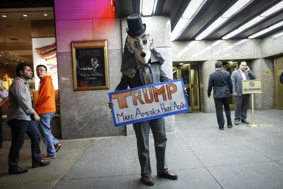 People protest in  front of NBC studios while they are calling for the network to rescind the invitation to Donald Trump to host Saturday Night Live show on November 4, 2015 in New York.