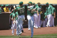 Oakland Athletics' Matt Chapman (26) is congratulated by Matt Olson (28) after hitting a home run against the Kansas City Royals during the first inning of a baseball game in Oakland, Calif., Sunday, June 13, 2021. (AP Photo/Jeff Chiu)