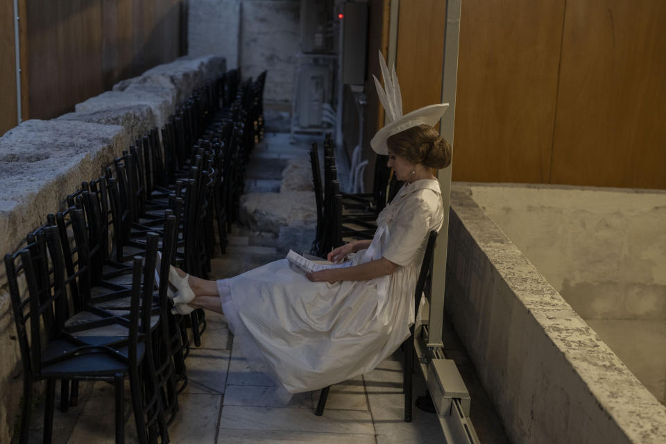 A performer reads music at the backstage of the Odeon of Herodes Atticus for a performance of "Madame Butterfly" in Athens, on Friday, June 1, 2023. The annual arts festival in Athens and at the ancient theater of Epidaurus in southern Greece is dedicated this year to the late opera great Maria Callas who was born 100 years ago. (AP Photo/Petros Giannakouris)