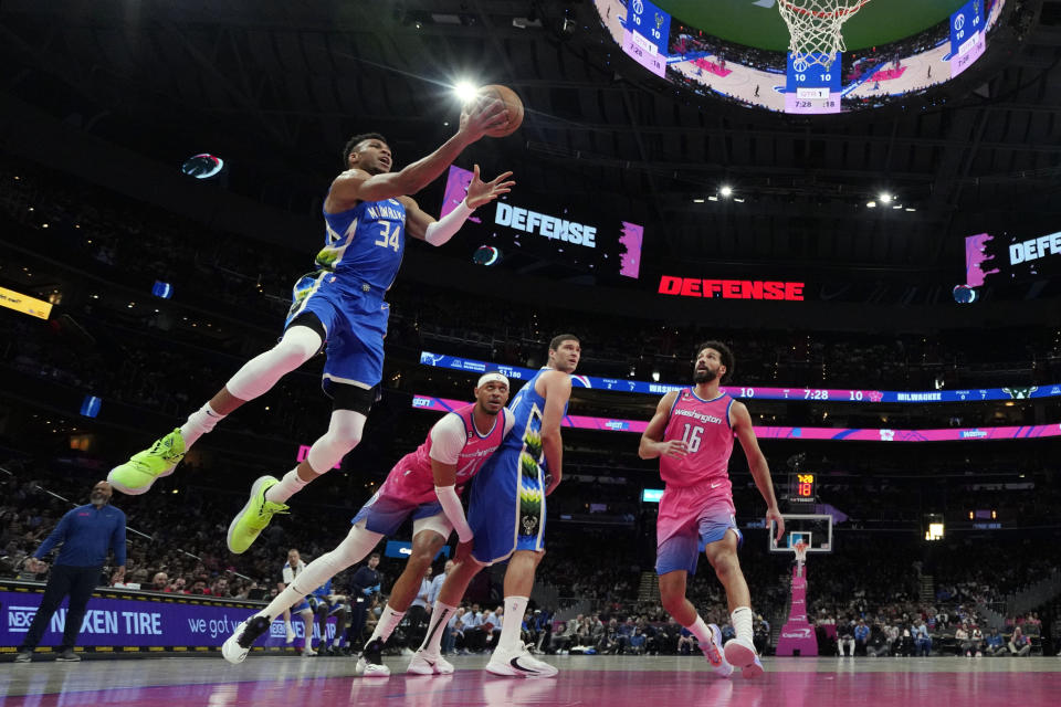 Milwaukee Bucks forward Giannis Antetokounmpo (34) goes up against Washington Wizards forward Anthony Gill (16) during the first half of an NBA basketball game, Tuesday, April 4, 2023, in Washington. (AP Photo/Jess Rapfogel)