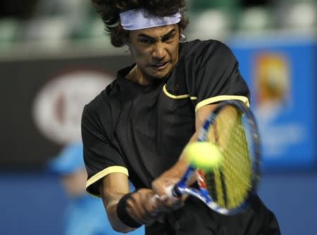 File photo of Nick Lindahl returning a shot against Finland's Jarkko Nieminen at the Australian Open tennis tournament in Melbourne January 18, 2010. REUTERS/Daniel Munoz