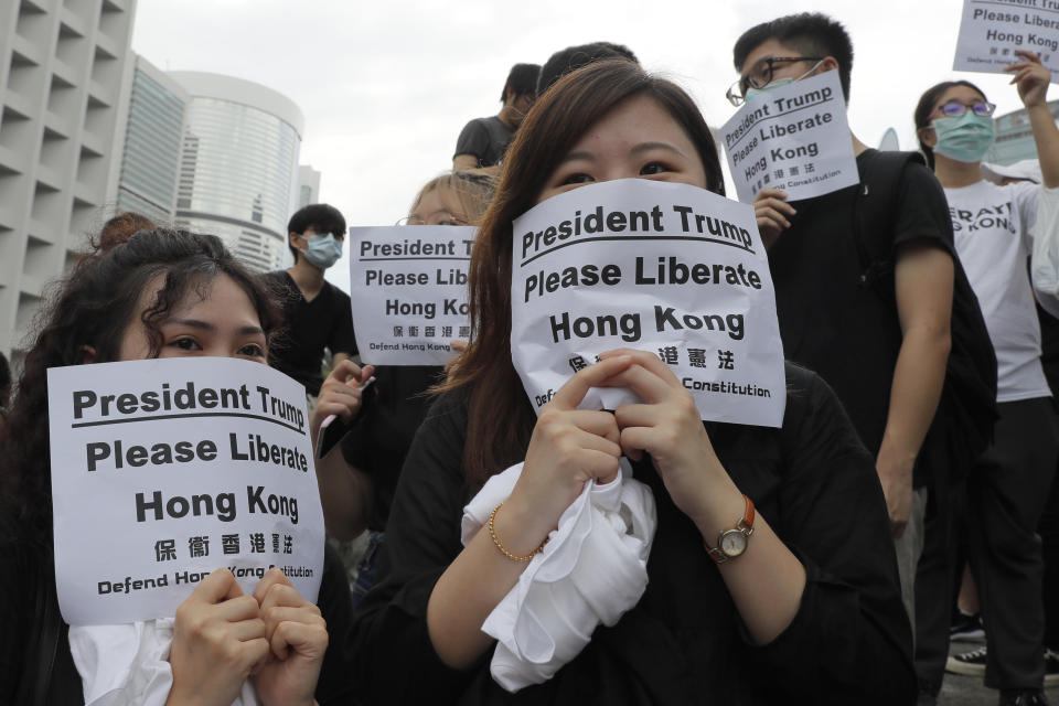 Protesters gather outside the U.S. Consulate in Hong Kong, Wednesday, June 26, 2019. Hong Kong activists opposed to contentious extradition legislation on Wednesday called on leaders of the U.S., the European Union and others to raise the issue with Chinese President Xi Jinping at this week's G-20 summit in Japan. (AP Photo/Kin Cheung)