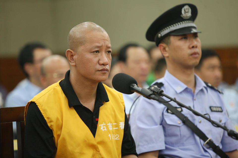 In this photo provided by China's Xinhua News Agency, defendant Lu Yueting, left, stands on trial at the Shijiazhuang Intermediate People's Court in Shijiazhuang, capital of north China's Hebei Province, Tuesday, July 30, 2013. The former food plant worker in China on Tuesday confessed in court to poisoning frozen dumplings that sickened 10 people in Japan in 2008, a scandal that strained Beijing-Tokyo relations just months before China hosted the Olympic Games. (AP Photo/Xinhua, Ding Lixin) NO SALES