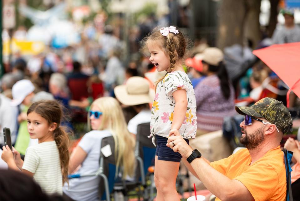 Evie Page watches the annual Days of ’47 Parade from her father Curtis Page’s lap in Salt Lake City on Monday, July 24, 2023. | Megan Nielsen, Deseret News