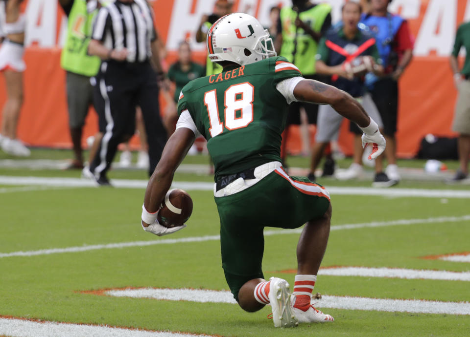 Miami wide receiver Lawrence Cager (18) scores a touchdown during the first half of an NCAA college football game against Florida State, Saturday, Oct. 6, 2018, in Miami Gardens, Fla. (AP Photo/Lynne Sladky)