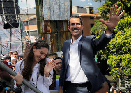 Venezuelan opposition leader and self-proclaimed interim president Juan Guaido and his wife Fabiana Rosales gesture during a rally against Venezuelan President Nicolas Maduro's government in Caracas, Venezuela February 2, 2019. REUTERS/Carlos Barria