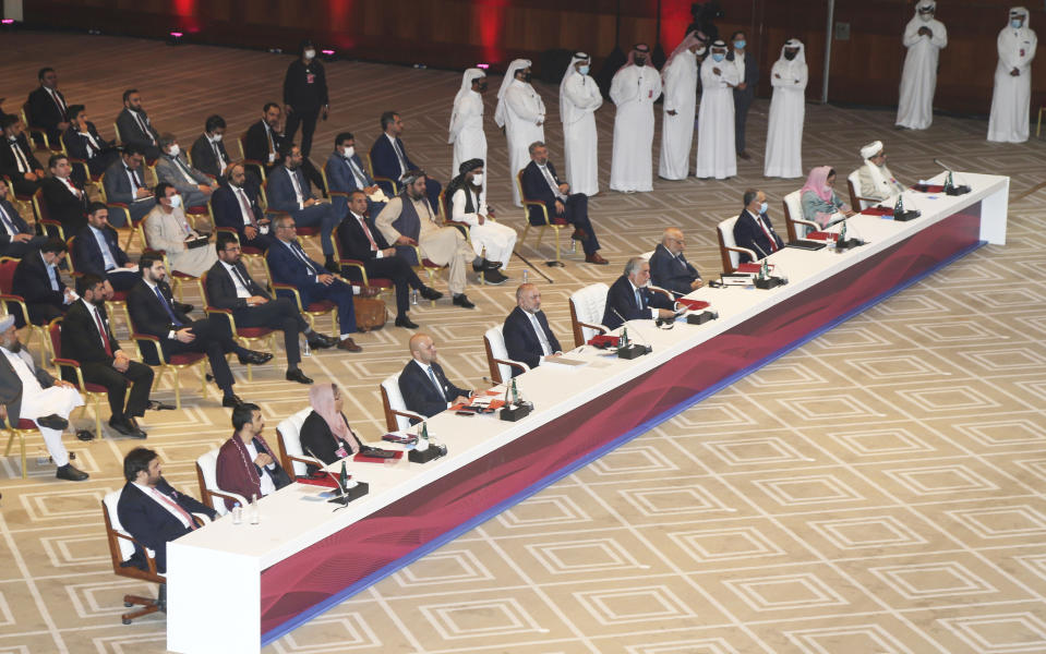 Abdullah Abdullah, center, chairman of Afghanistan's High Council for National Reconciliation, talks at the opening session of the peace talks between the Afghan government and the Taliban in Doha, Qatar, Saturday, Sept. 12, 2020. (AP Photo/Hussein Sayed)