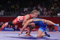 <p>Belarus' Iryna Kurachkina (red) wrestles Russia's Valeria Koblova in their women's freestyle 57kg wrestling quarter final match during the Tokyo 2020 Olympic Games at the Makuhari Messe in Tokyo on August 4, 2021. (Photo by Jack GUEZ / AFP)</p> 