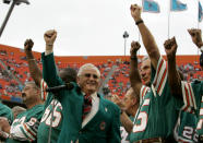 FILE - In this Dec. 16, 2007 file photo, former Miami Dolphins coach Don Shula, left, and player Nick Buoniconti, right, wave during a halftime ceremony honoring the 1972 perfect season of the Dolphins during an NFL football game against the Baltimore Ravens at Dolphin Stadium in Miami. Pro Football Hall of Fame middle linebacker Nick Buoniconti, an undersized overachiever who helped lead the Miami Dolphins to the NFL's only perfect season, has died at the age of 78. Bruce Bobbins, a spokesman for the Buoniconti family, said he died Tuesday, July 30, 2019, in Bridgehampton, N.Y. (AP Photo/Lynne Sladky, File)