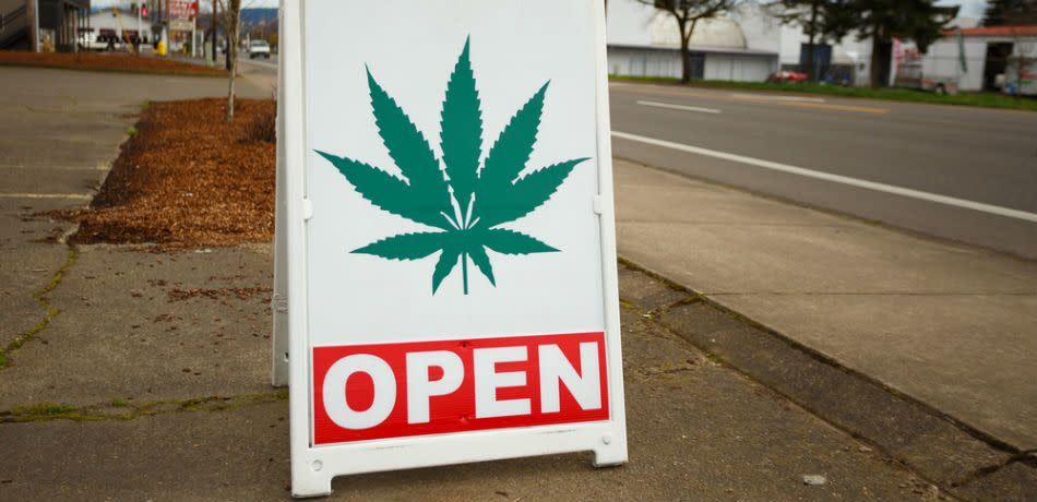 A sign in front of a cannabis dispensary.