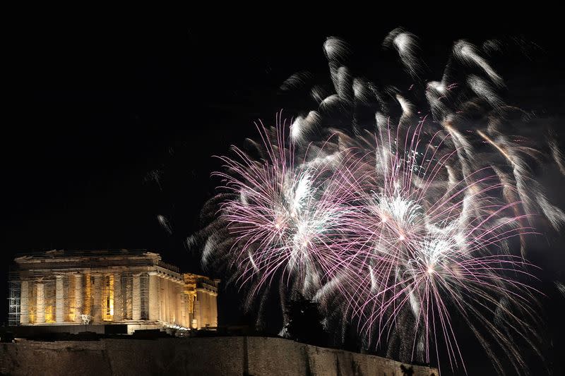 Fireworks explode over the ancient Parthenon temple atop the Acropolis hill during New Year's day celebrations in Athens