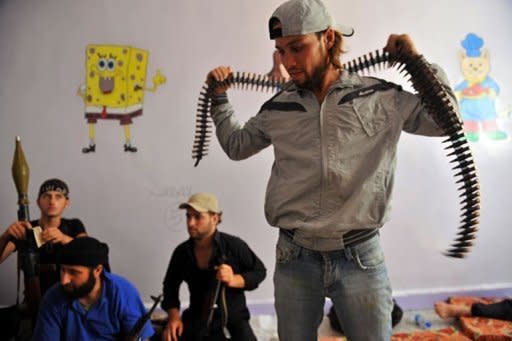 Fighters from the Syrian opposition rest at a former primary school in the center of Syria's restive northern city of Aleppo. The Syrian army and rebels on Wednesday sent reinforcements to Aleppo to join the intensifying battle for the country's second city, as UN chief Ban Ki-moon urged the world "to stop the slaughter."