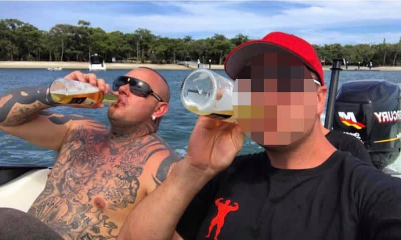 A heavily tattooed Ross seen on the back of a boat, drinking beers with a friend. 