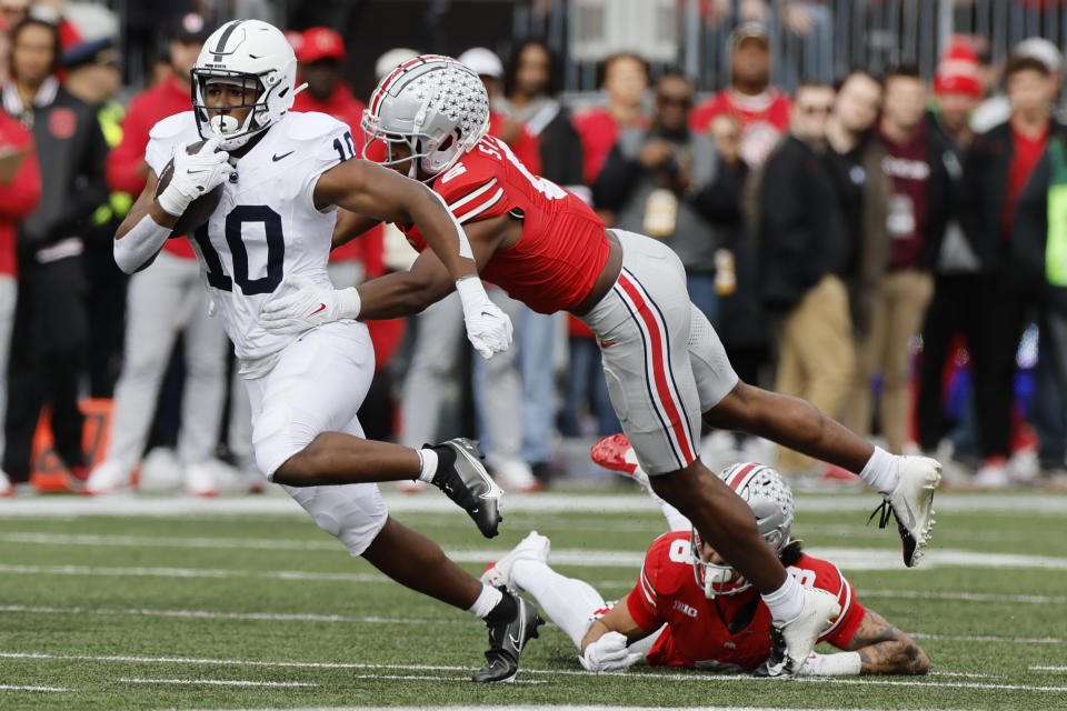 Penn State running back Nicholas Singleton, left, tries to get away from Ohio State defensive back Sonny Styles during the first half of an NCAA college football game Saturday, Oct. 21, 2023, in Columbus, Ohio. (AP Photo/Jay LaPrete)
