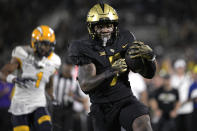 Central Florida running back RJ Harvey (7) rushes for a 48-yard touchdown as Kent State cornerback Capone Blue (1) trails the play during the second half of an NCAA college football game, Thursday, Aug. 31, 2023, in Orlando, Fla. (AP Photo/Phelan M. Ebenhack)