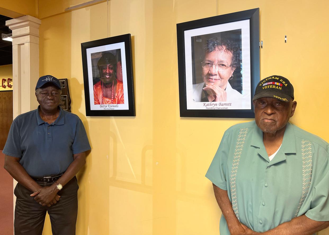 Claude Burnett, left, board chairman of the Central-Carver Museum, and Taylor Knowles III, the museum's fiscal officer, are pictured with photos of Bettye Knowles and Kathryn Barrett, the museum's founders.