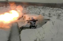 In this photo taken from video provided by the Russian Defense Ministry Press Service on Tuesday, Jan. 25, 2022, A Russian paratrooper attends a military exercising at the Pesochnoe training ground in the Yaroslavl region, Russia, (Russian Defense Ministry Press Service via AP)