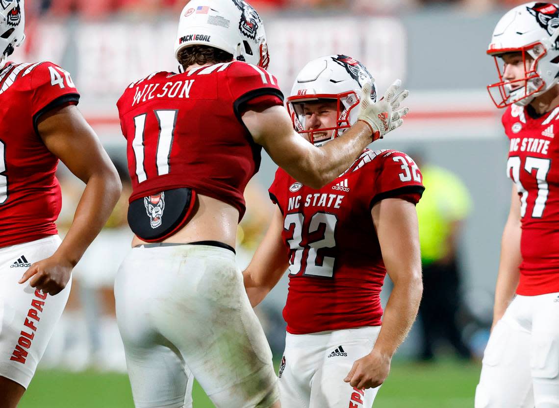 N.C. State linebacker Payton Wilson (11) congratulates kicker Christopher Dunn (32) after he hit a 51-yard field goal during the second half of N.C. State’s 30-21 victory over Wake Forest at Carter-Finley Stadium in Raleigh, N.C., Saturday, Nov. 5, 2022.