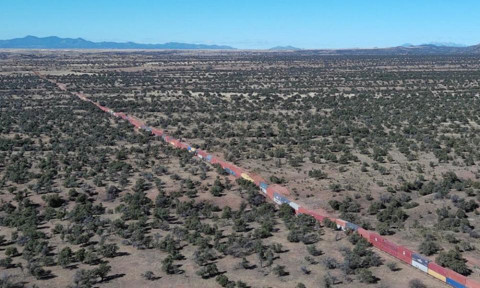 A long row of shipping containers stacked to create a wall between the US and Mexico awaits removal in the Coronado National Forest, Arizona.