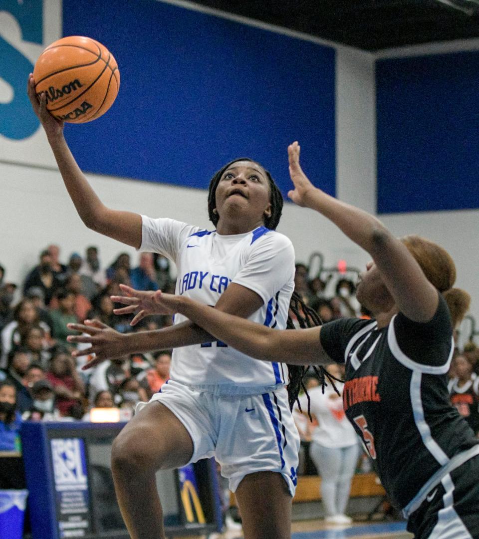 Wildwood's Trinidy Harris (11) tries to score during the Class 1A-Region 4 championship game against Hawthorne High School in Wildwood on Feb. 11, 2022.