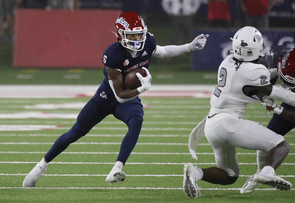 Fresno State Jalen Cropper looks to avoid UNLV defensive back Nohl Williams during the first half of an NCAA college football game in Fresno, Calif., Friday, Sept. 24, 2021. (AP Photo/Gary Kazanjian)