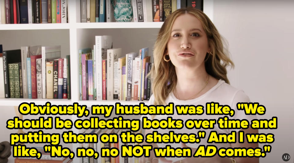 Ashley in white tee smiling in front of a bookshelf