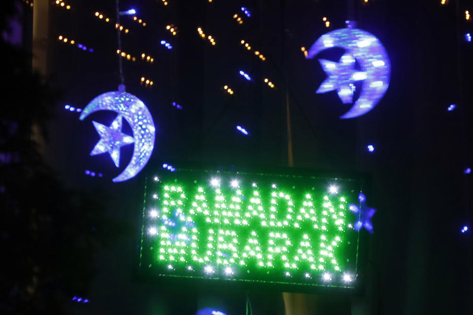 In this Tuesday, April 28, 2020 photo, Ramadan lights are displayed on a house in Dearborn, Mich. The Muslim community in Dearborn is starting a new tradition this year. The community is hosting a Ramadan lights competition in hopes of spreading joy and bringing back some of the holiday spirit during the coronavirus pandemic. (AP Photo/Carlos Osorio)