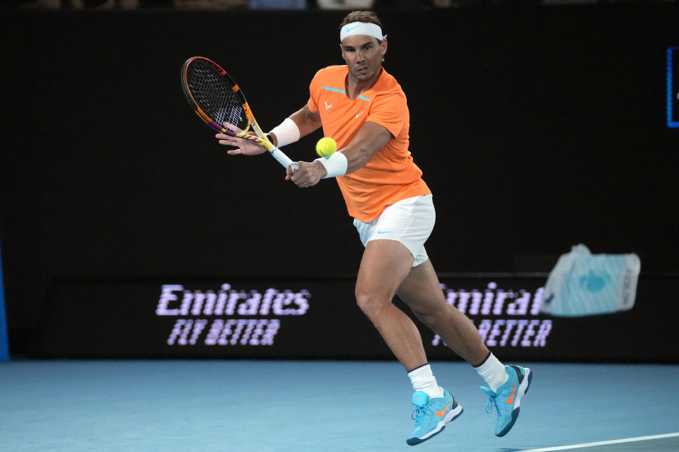 FILE - Rafael Nadal, of Spain, plays a backhand return to Mackenzie McDonald, of the U.S., during their second-round match at the Australian Open tennis championship in Melbourne, Australia, Jan. 18, 2023. Nadal had arthroscopic surgery on Friday, June 2, 2023, for the injured left hip flexor that forced him to sit out the French Open for the first time since he won the first of his record 14 titles there in his 2005 tournament debut. (AP Photo/Dita Alangkara, File)