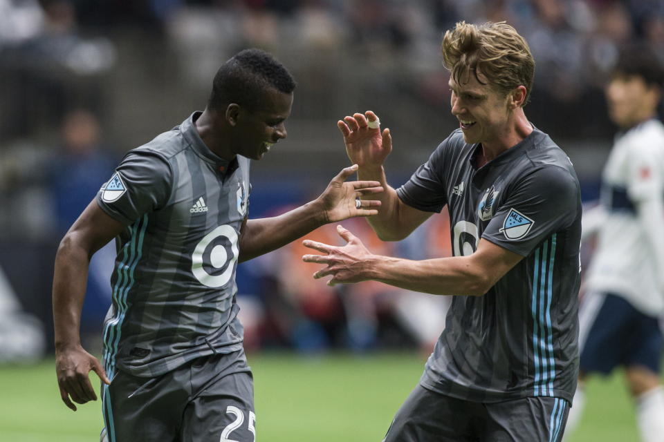 Minnesota United's Carlos Darwin Quintero (25) celebrates his goal with Rasmus Schuller during the first half of an MLS soccer match against the Vancouver Whitecaps on Saturday, March 2, 2019, in Vancouver, British Columbia. (Ben Nelms/The Canadian Press via AP)