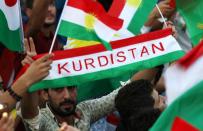 <p>Iraqi Kurds fly Kurdish flags during an event on Sept. 16, 2017, to urge people to vote in the upcoming independence referendum in Arbil, the capital of the autonomous Kurdish region of northern Iraq. (Photo: Safin Hamed/AFP/Getty Images) </p>