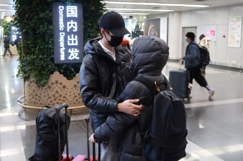 Passengers wearing masks are seen at the terminal hall of the Beijing Capital International Airport, in Beijing