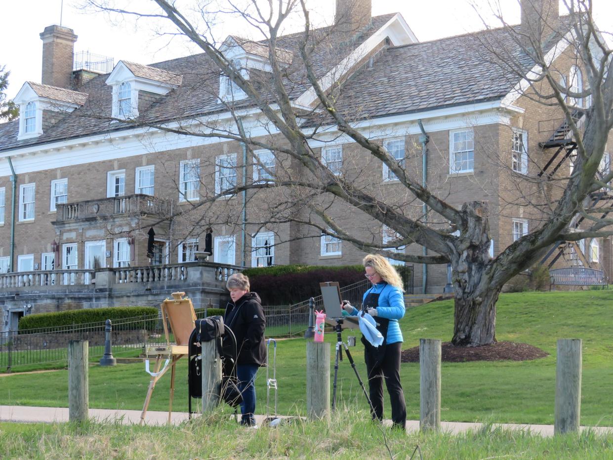 Theresa Frank, left, and Terrie Anderson, right, paint at the Felt Estate on Saturday, April 20.