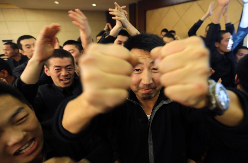 Chen Yongqing, the owner of Tianjiao Special Guard/Security Consultant gestures during a group dinner with his students on the outskirts of Beijing December 14, 2013. Former Chinese soldier Chen has big ambitions for his bodyguard training school Tianjiao, which he says is China's first professional academy to train former soldiers and others as personal security guards. Chen charges 500,000 yuan ($82,400) a year for each protector as China's rich and famous look to bolster their safety and sense of importance. Picture taken December 14, 2013. REUTERS/Jason Lee (CHINA - Tags: BUSINESS SOCIETY) ATTENTION EDITORS: PICTURE 22 OF 26 FOR PACKAGE 'CHINA'S BODYGUARD SCHOOL' TO FIND ALL IMAGES SEARCH 'TIANJIAO'