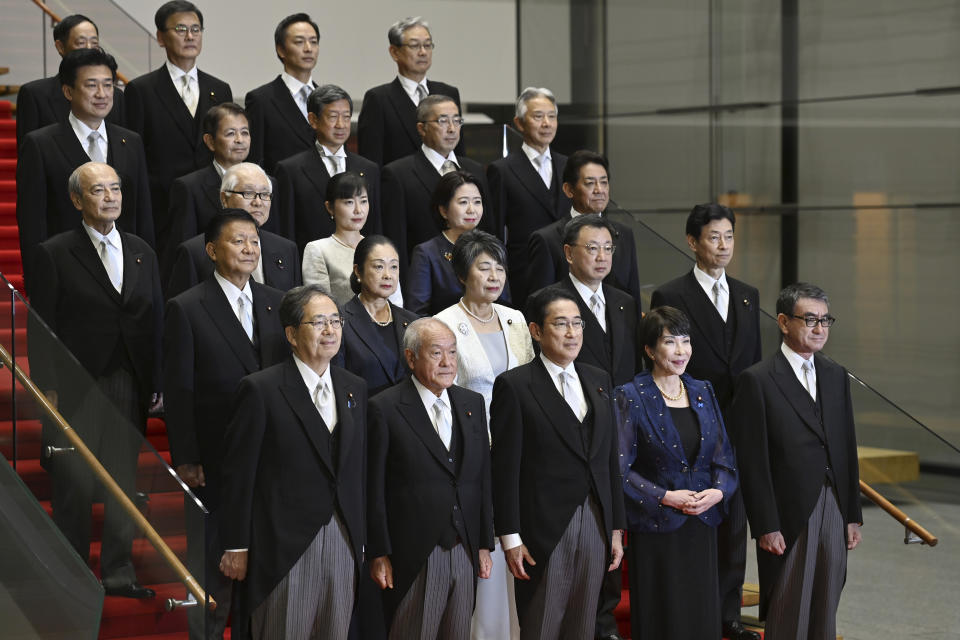 Japanese Prime Minister Fumio Kishida, center, bottom row, poses with his new cabinet members in Tokyo, Japan, Wednesday, Sept. 13, 2023, after a cabinet reshuffle. (David Mareuil/Pool Photo via AP)