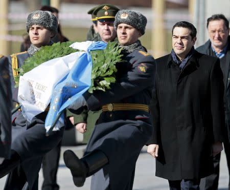 Greek Prime Minister Alexis Tsipras (R) takes part in a wreath laying ceremony at the Tomb of the Unknown Soldier by the Kremlin walls in central Moscow, April 8, 2015. REUTERS/Ivan Sekretarev