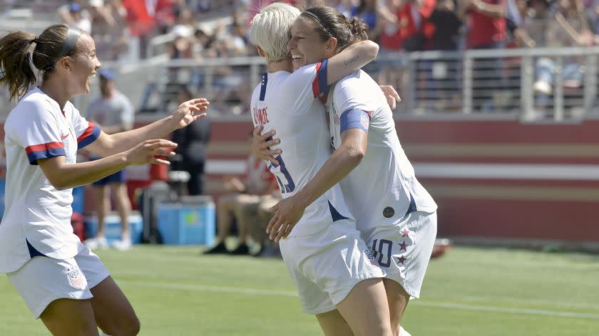 Carli Lloyd (10) gets a hug from forward Megan Rapinoe (15) after scoring a goal for the U.S.