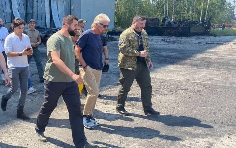 Richard Branson (second right) met local officials at the Antonov airport terminal at Hostomel - Taras Dumenko/via Reuters