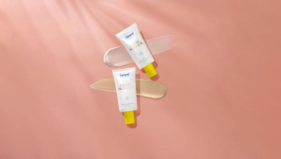 2 tubes of Glowscreen Dawn Broad Spectrum Sunscreen are laid against a beige backdrop with 2 smears.