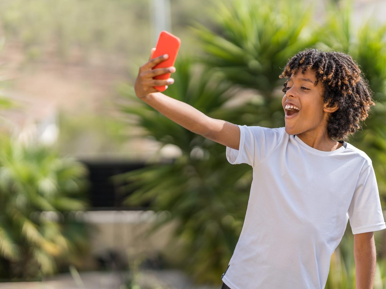 Boy taking a selfie with a phone