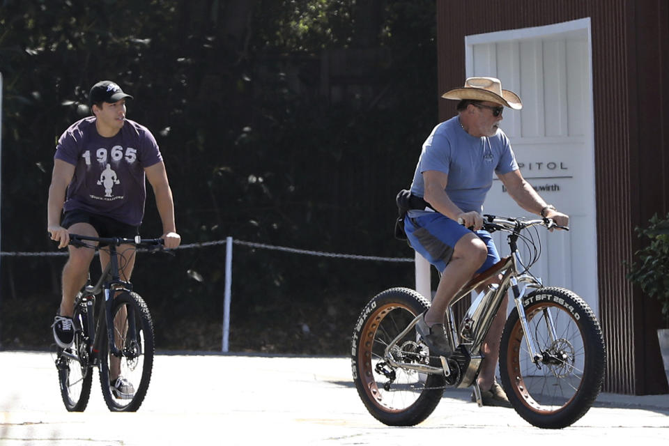 LOS ANGELES, CA - JULY 19: Arnold Schwarzenegger seen biking at the Brentwood Country Mart with son Joseph Baena and girlfriend in Los Angeles, California on July 19, 2020. Credit: mpi99/MediaPunch /IPX