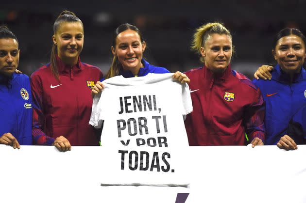 Players from Spain's Barcelona and Mexico's Club América teams hold a shirt Tuesday before a friendly match in Mexico City that translates to: 