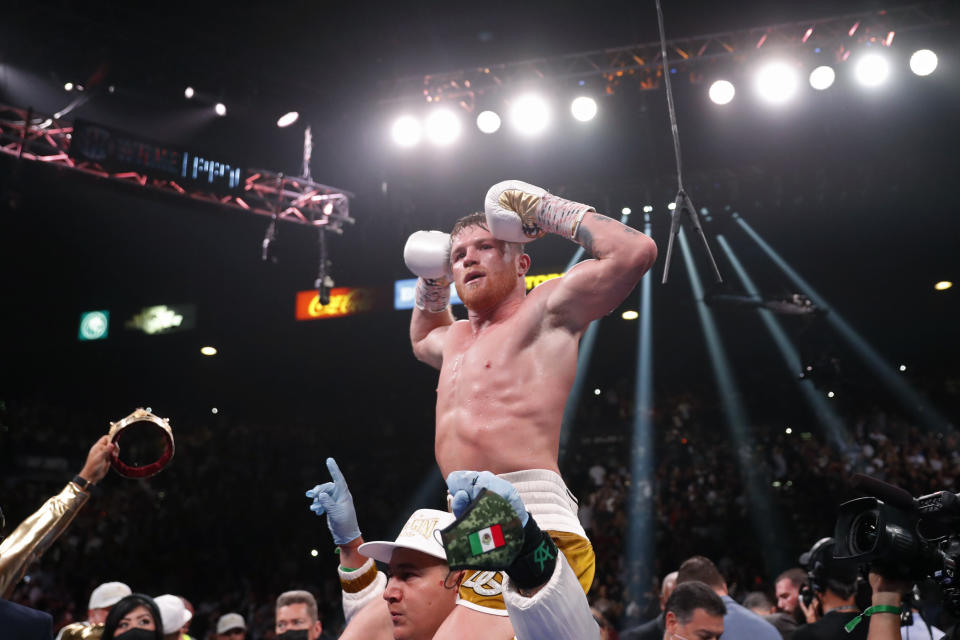 Canelo Alvarez, of Mexico, celebrates after defeating Caleb Plant in a super middleweight title unification fight Saturday, Nov. 6, 2021, in Las Vegas. (AP Photo/Steve Marcus)