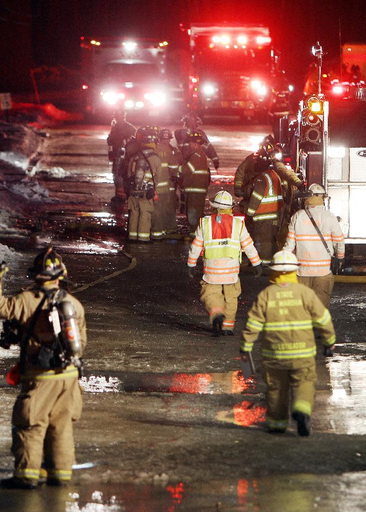 Emergency crews from several towns work an area outside the New Hampshire Ball Bearing plant after an explosion, Monday, Feb. 10, 2014 in Peterborough, N.H. At least 13 people were injured, but a company spokeswoman says none of the injuries appears to be life-threatening. (AP Photo/Jim Cole)