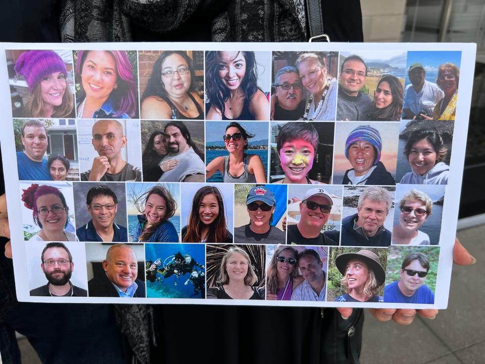 Kathleen McIlvain, the mother of a man killed in a boat fire that killed 34 people off the Santa Barbara coast in 2019, holds up a picture showing the victims of the disaster on Wednesday, Oct. 25, 2023, outside federal court in Los Angeles.