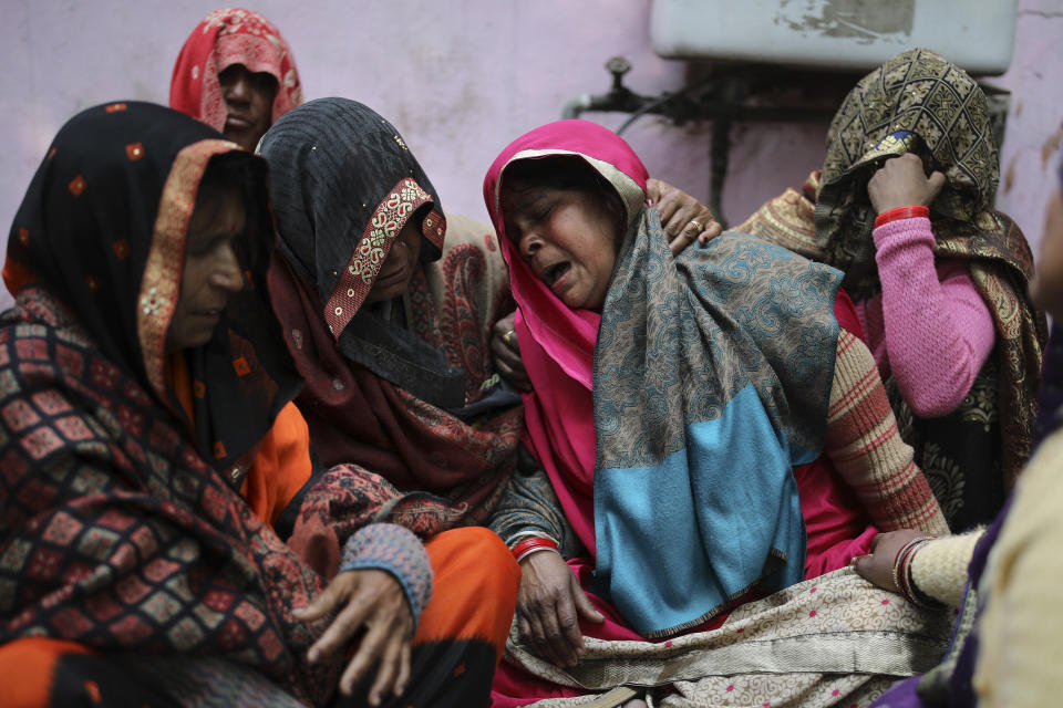 Family members of Rahul Solanki, who was killed during clashes between Hindu mobs and Muslims protesting a contentious new citizenship law, weep outside a mortuary in New Delhi, India, Wednesday, Feb. 26, 2020. At least 20 people were killed in three days of clashes in New Delhi, with the death toll expected to rise as hospitals were overflowed with dozens of injured people, authorities said Wednesday. The clashes between Hindu mobs and Muslims protesting a contentious new citizenship law that fast-tracks naturalization for foreign-born religious minorities of all major faiths in South Asia except Islam escalated Tuesday. (AP Photo/Altaf Qadri)